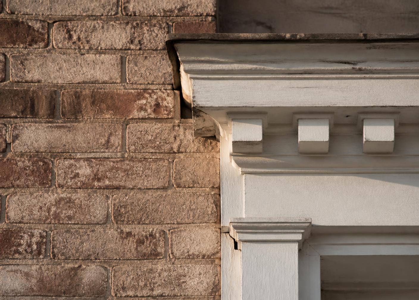 Architectural detail of brick and painted cornice molding